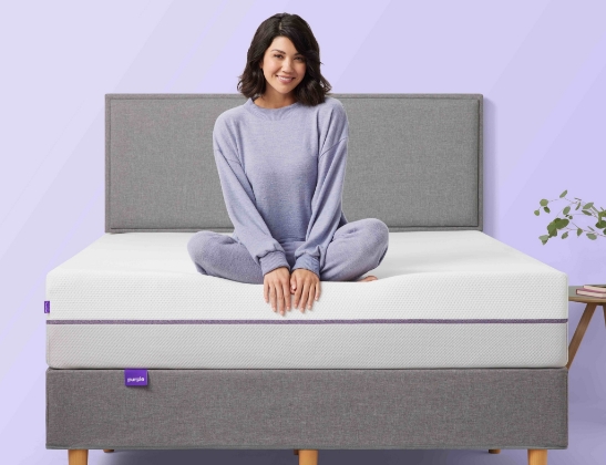 woman smiling on purple mattress